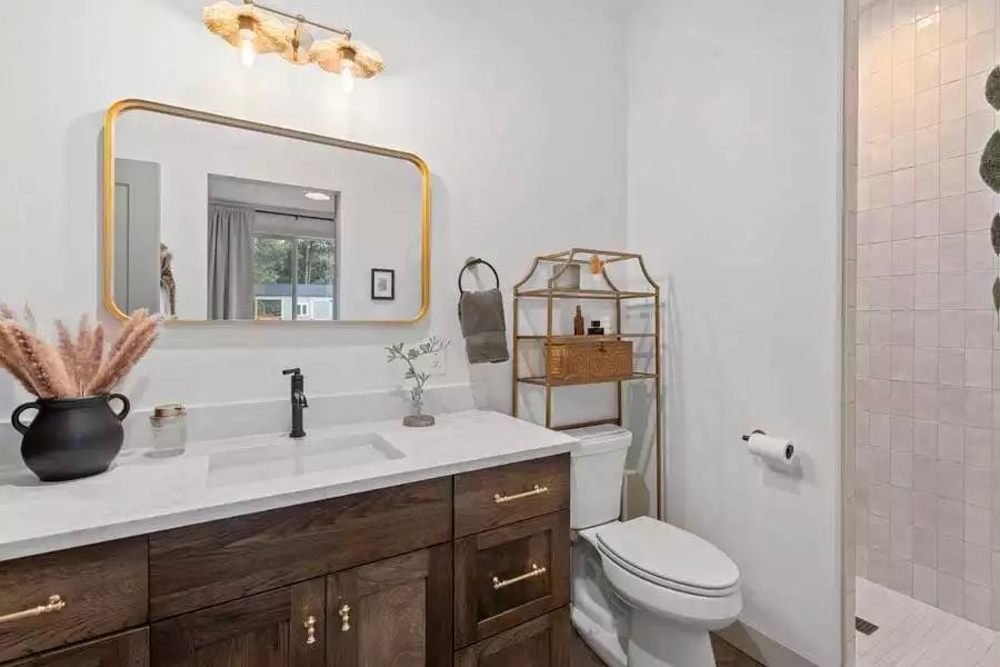 Gold Mirror, Black Faucet, and a Vanity Cabinet That Means Business