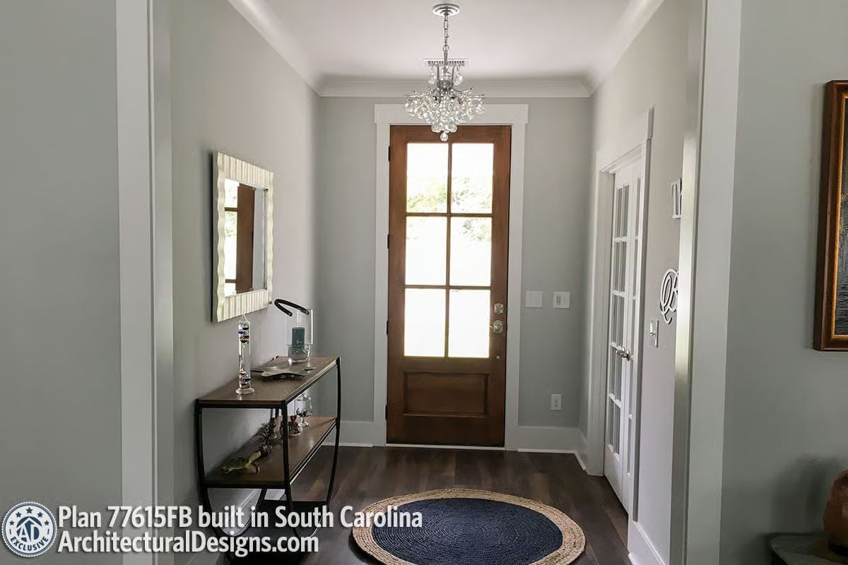 Crystal Chandelier and Warm Wood Door Set the Tone Before You're Inside