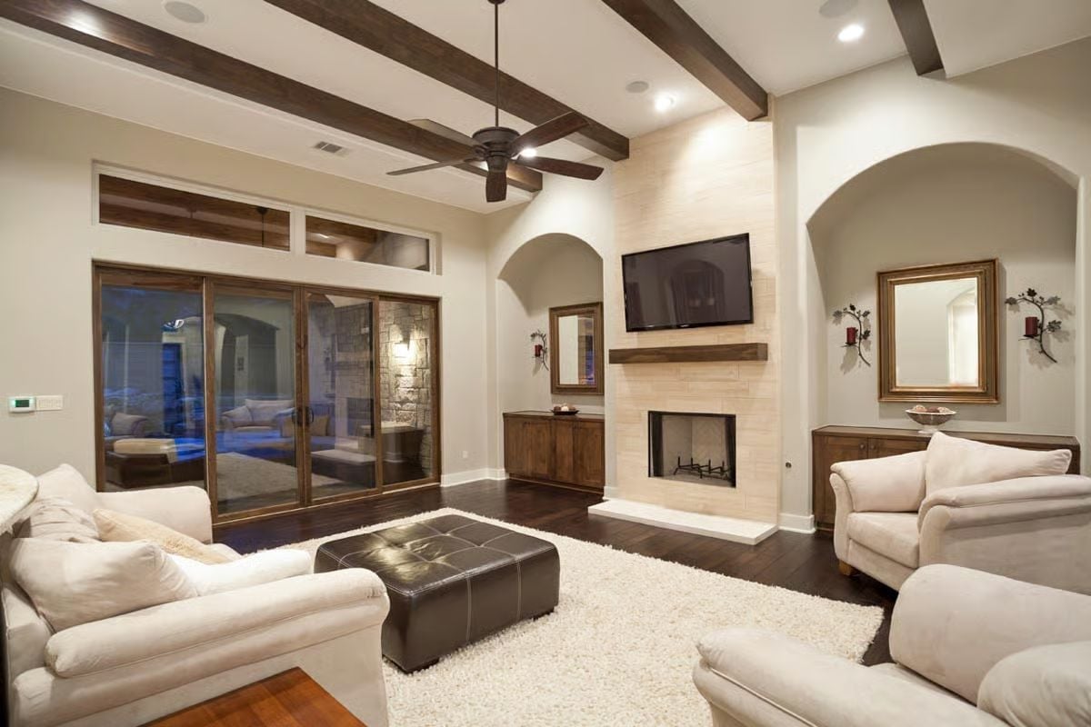 Exposed Ceiling Beams, Stone Fireplace, and Sofas That Actually Look Comfortable