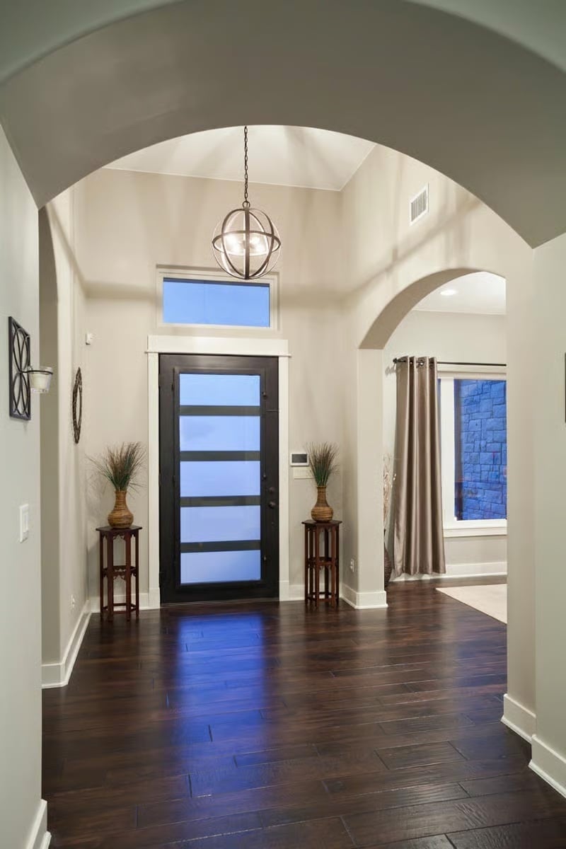 Orb Pendant, Arched Passages, and a Front Door That Earns Its Place