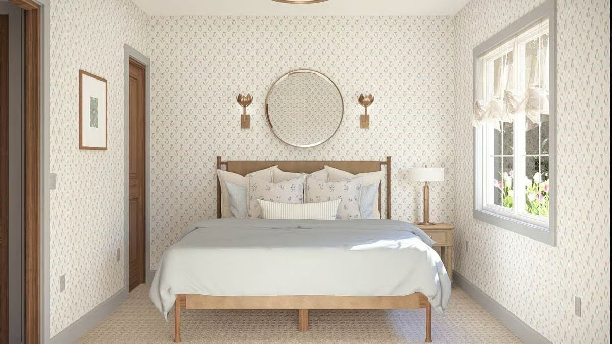 Gold Sconces and a Round Mirror Pull This Cottage Bedroom Into Focus