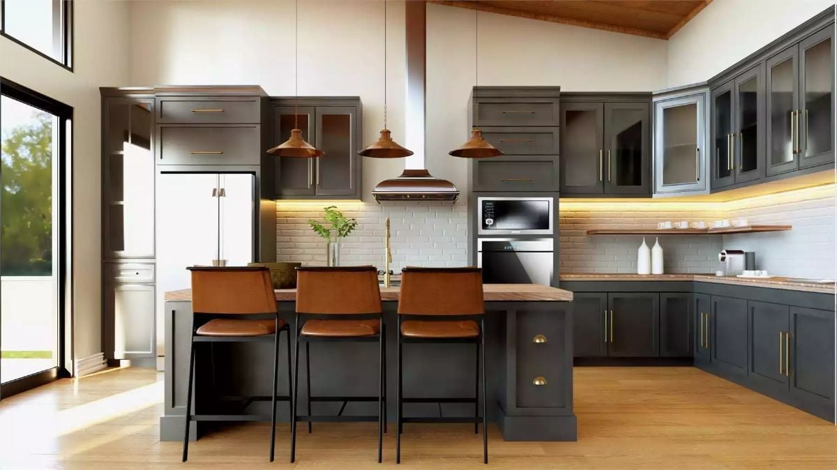 Copper Pendants and Cognac Leather Barstools Anchor a Dark Cabinet Kitchen