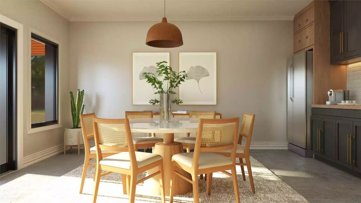 Rattan Chairs and a Marble Pedestal Table Pull Morning Light Into the Dining Room
