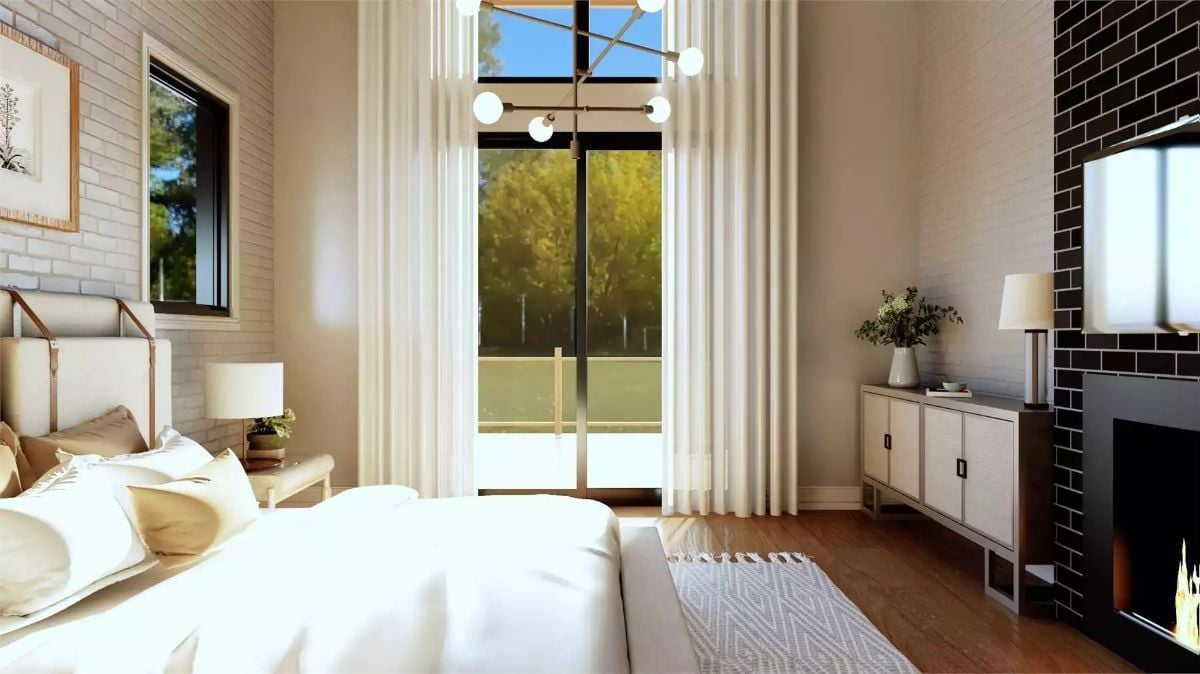Sheer Curtains Pool Onto Hardwood Where a Balcony Door Fills the Wall With Trees