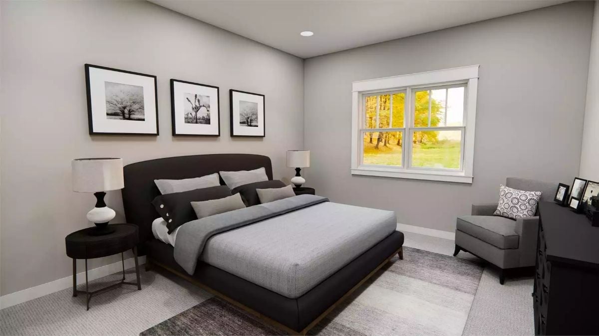 Black Upholstered Bed Against Gray Walls Earns Its Keep in This Primary Suite