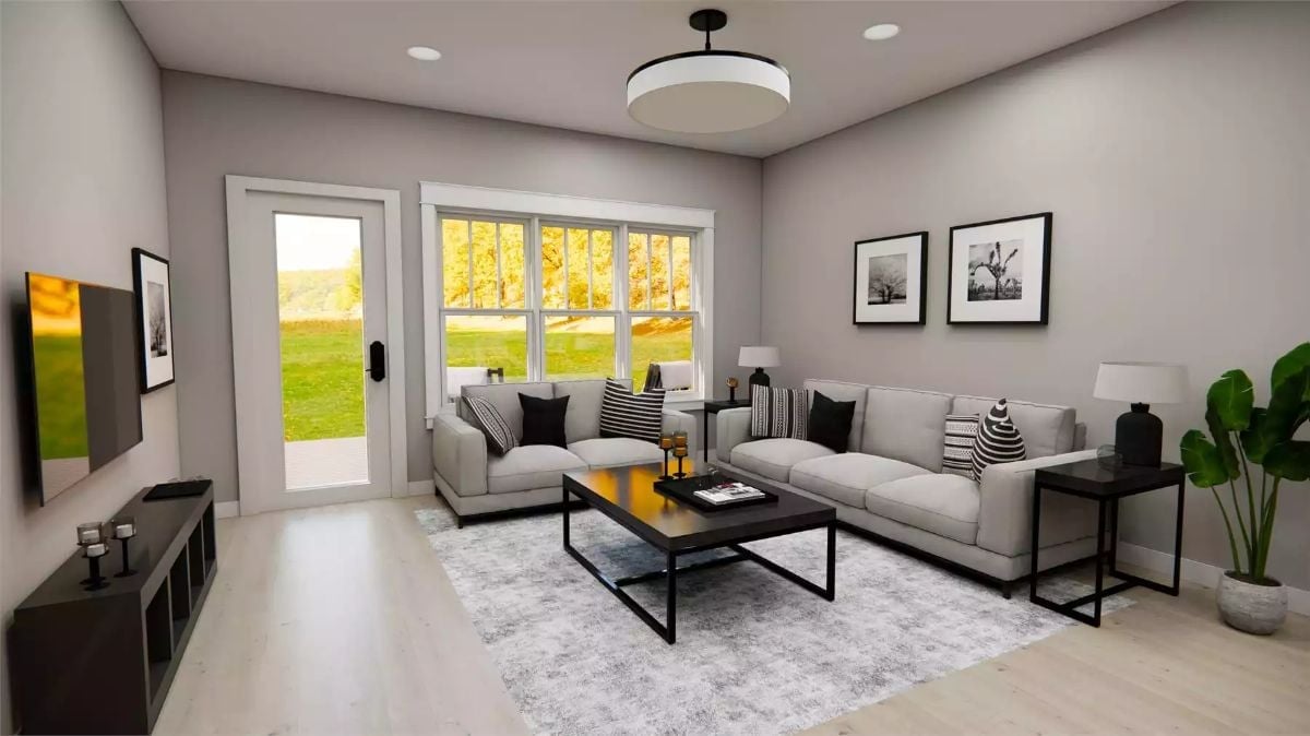 Monochrome Pillows and a Black Coffee Table Pull This Living Room Together