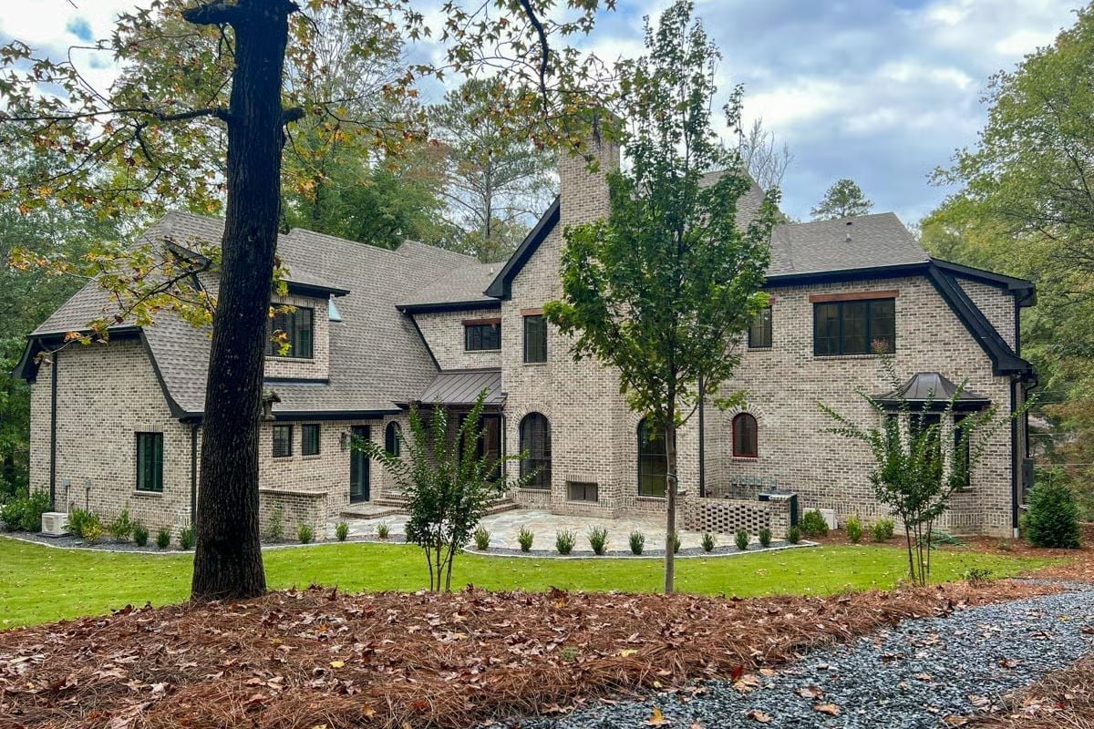 Pale Brick Exterior and Steep Rooflines That Mean Business