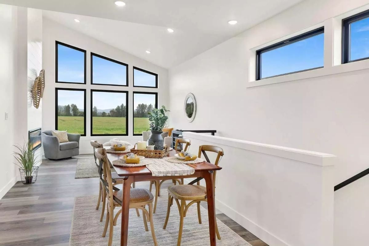 Black-Framed Windows Turn a Green Field View Into the Room's Best Feature
