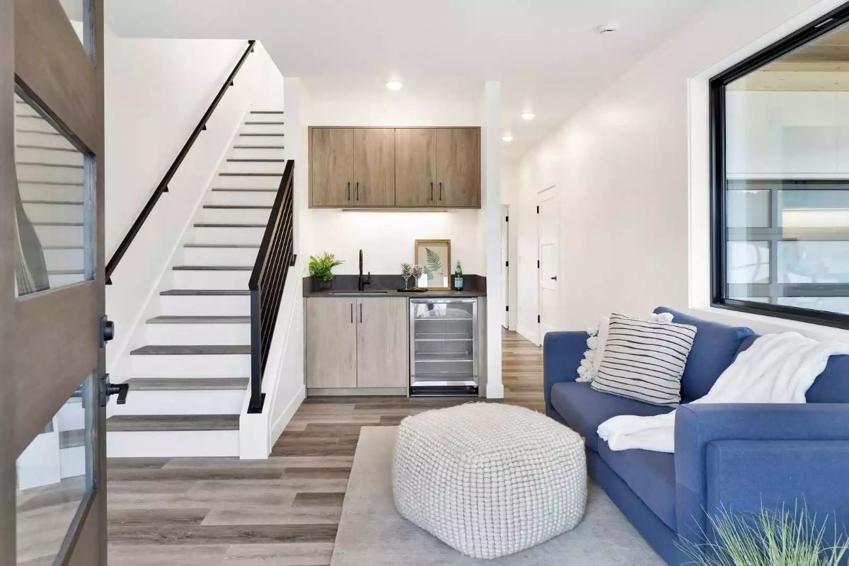 Wet Bar Tucked Under the Stairs Keeps the Living Room Clean and Functional
