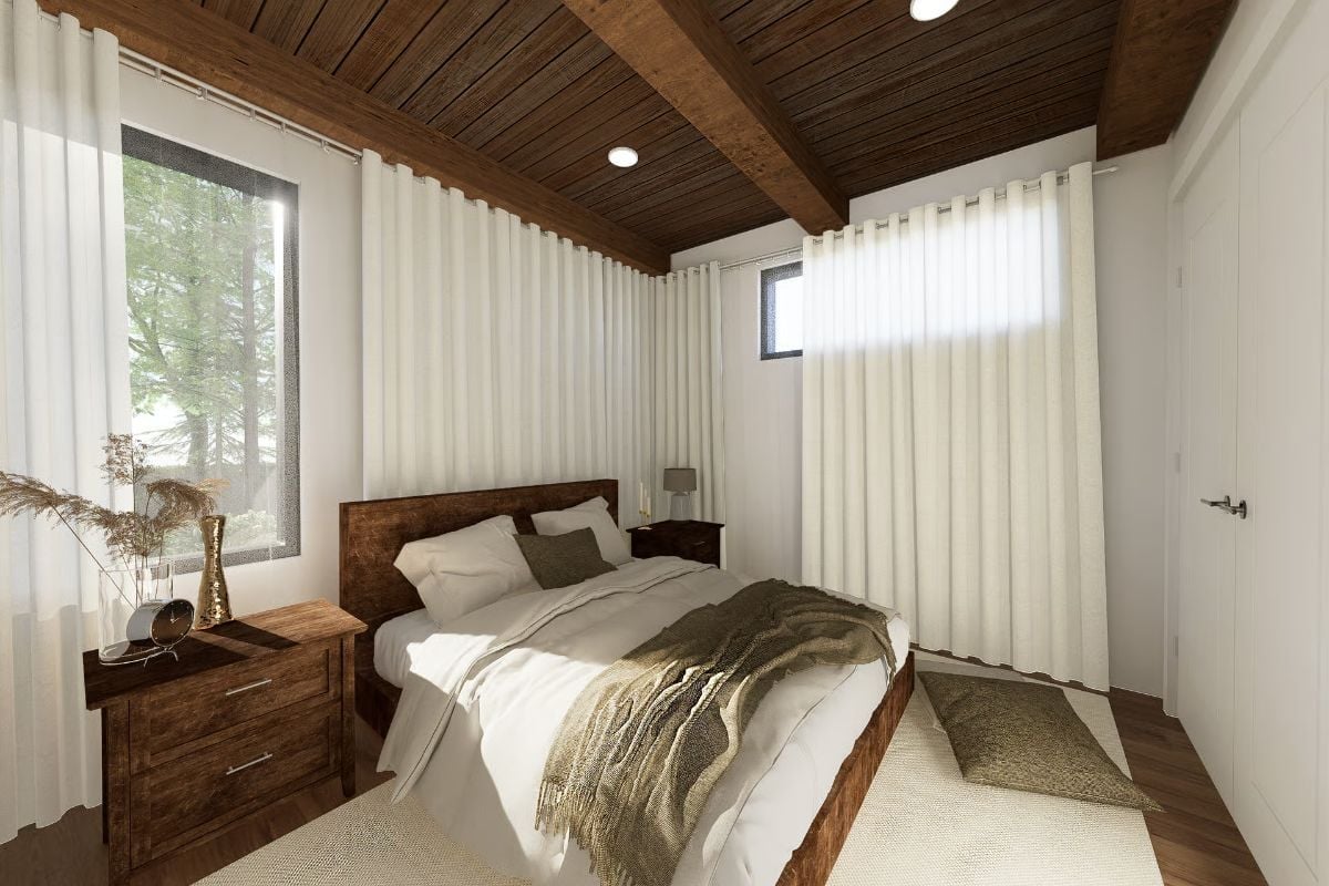 Dark Wood Ceiling Beams and White Linens Keep This Bedroom Grounded