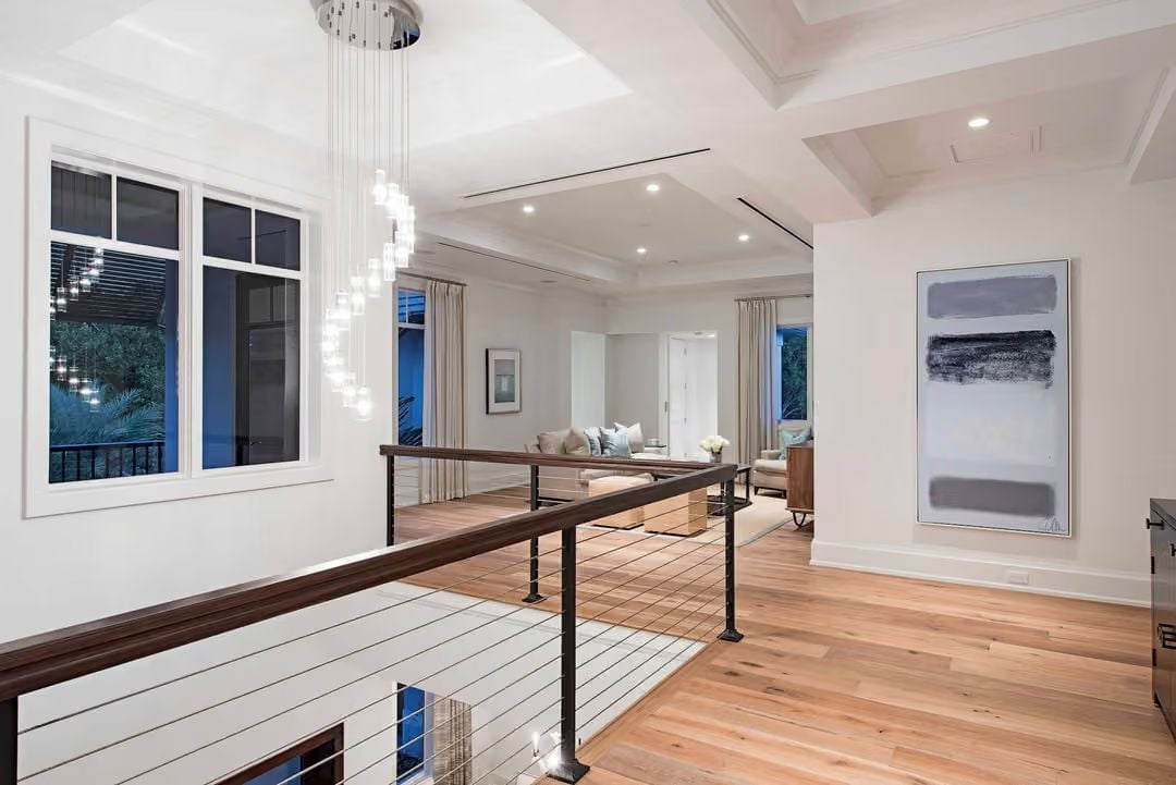 Cable Railing and Cascading Glass Pendants Own the Upper Hall