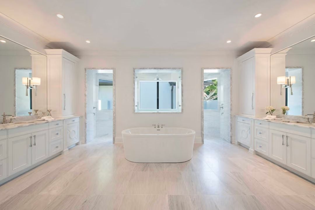 Dual Vanities Face Each Other Across a Freestanding Tub With Nowhere to Hide