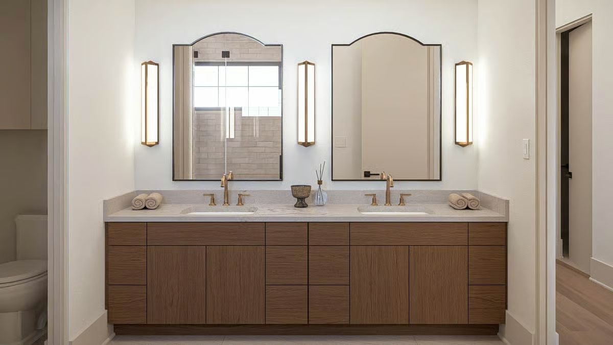Arch-Top Mirrors and Brass Sconces That Pull a Double Vanity Together