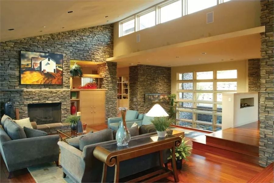 Stacked Stone Walls and Cherry Hardwood Make This Living Room Hard to Forget