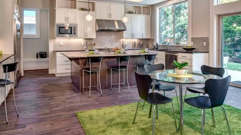 Chartreuse Rug and Glass Dining Table Pull Double Duty in an Open-Plan Kitchen