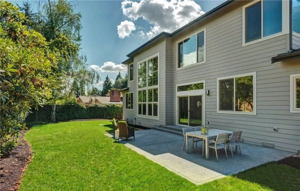 Concrete Patio and Wall-to-Wall Glass Turn the Backyard into an Extension of the House
