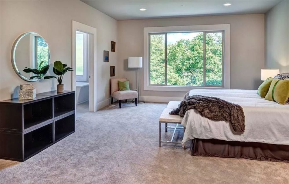 Olive Pillows and a Fur Throw Keep This Neutral Bedroom from Playing It Too Safe