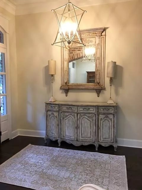 Distressed Sideboard and Gilt Mirror Set the Tone Before You Cross the Room