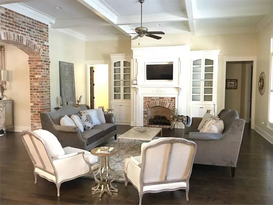 Exposed Brick Arch and French Wingbacks Share the Same Room Without Competing