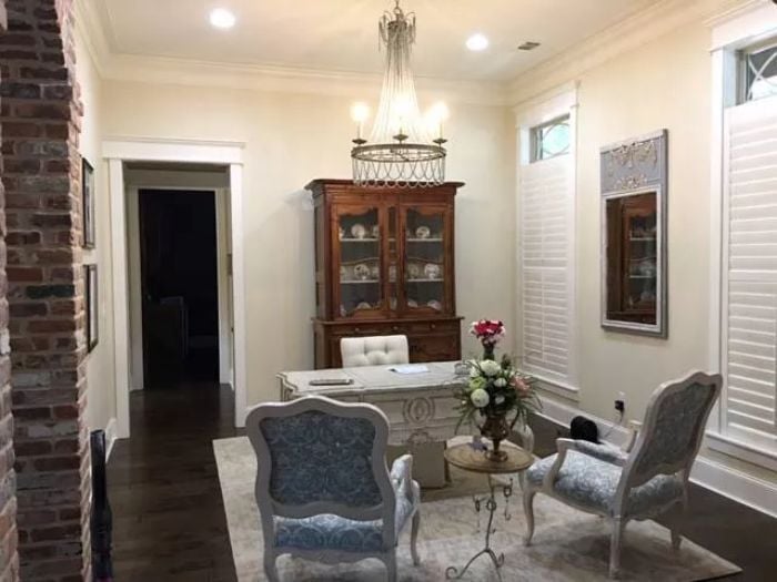 French Wingback Chairs and a Glass-Front Cabinet Make the Home Office Worth Staying In