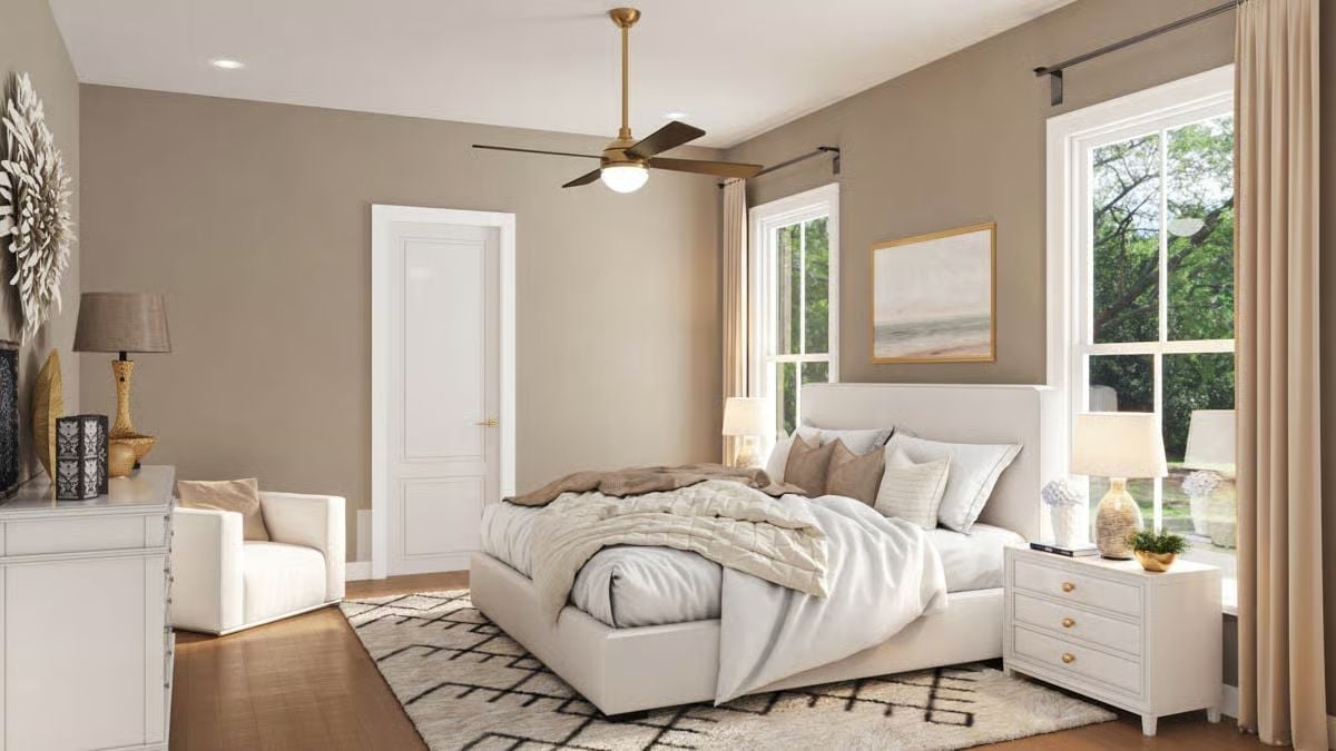 Brass Fan, Warm Taupe Walls, and a Bed That Looks Hard to Leave