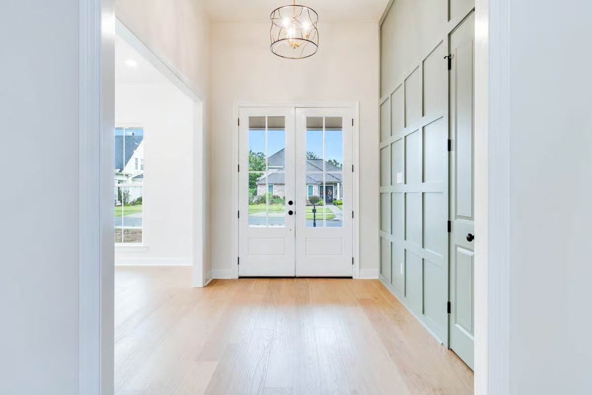 Sage Barn Doors and French Entry Make a Foyer Worth Arriving Into