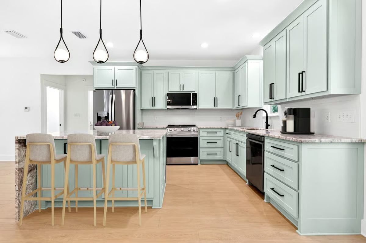 Mint Cabinets Get a Second Act With Black Hardware and Waterfall Stone