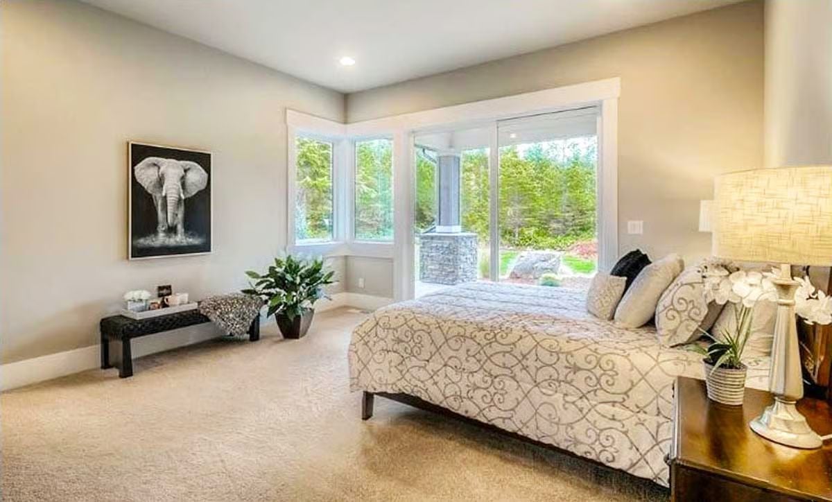 Elephant Art and Corner Windows Give This Master Bedroom Its Quiet Confidence