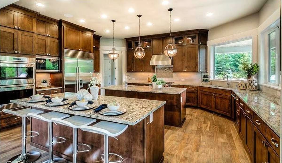 Warm Wood Cabinetry and Granite Islands Built for Serious Cooking and Easy Entertaining