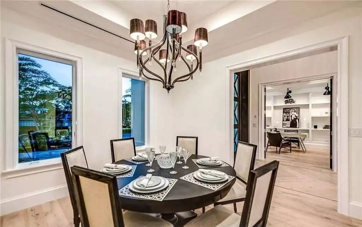 Dark Round Table, Bronze Chandelier, and a Room That Knows Its Own Scale