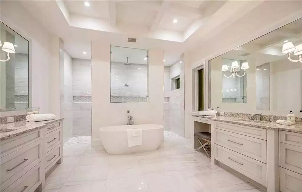 Freestanding Tub Centered Between Two Walk-In Showers Makes a Strong Architectural Argument