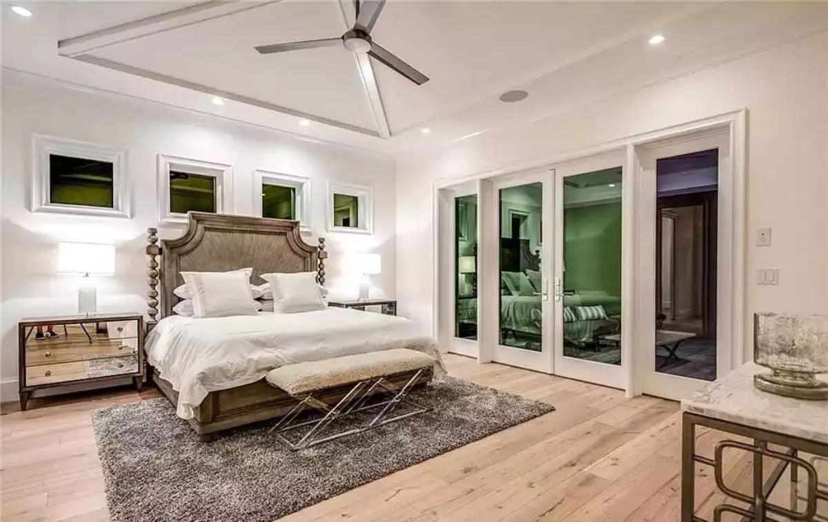 Spindle Headboard, Mirrored Nightstand, and French Doors That Borrow From the Next Room