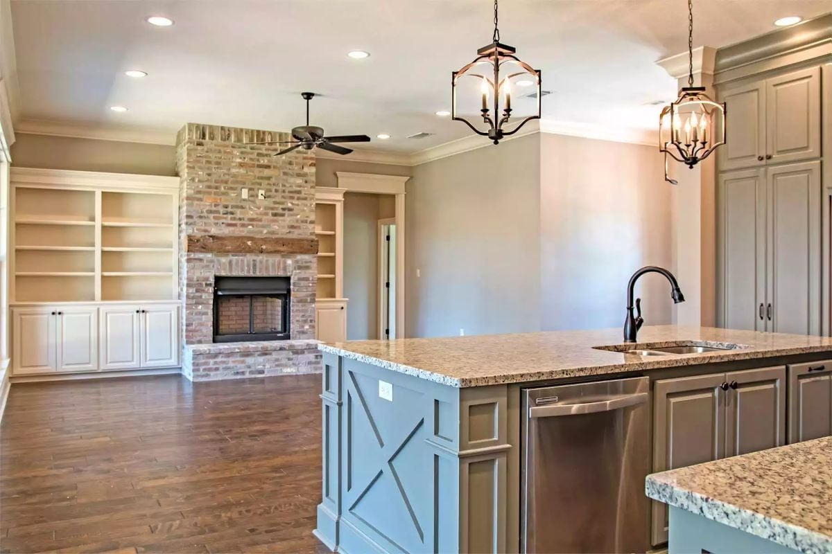 Brick Fireplace Flanked by Built-Ins Anchors the Open Living Space
