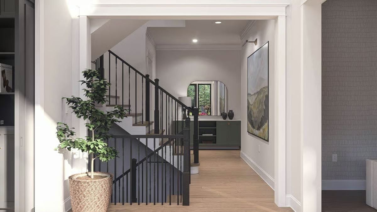 Black Iron Railings Against Pale Oak Floors Make the Staircase Do All the Work