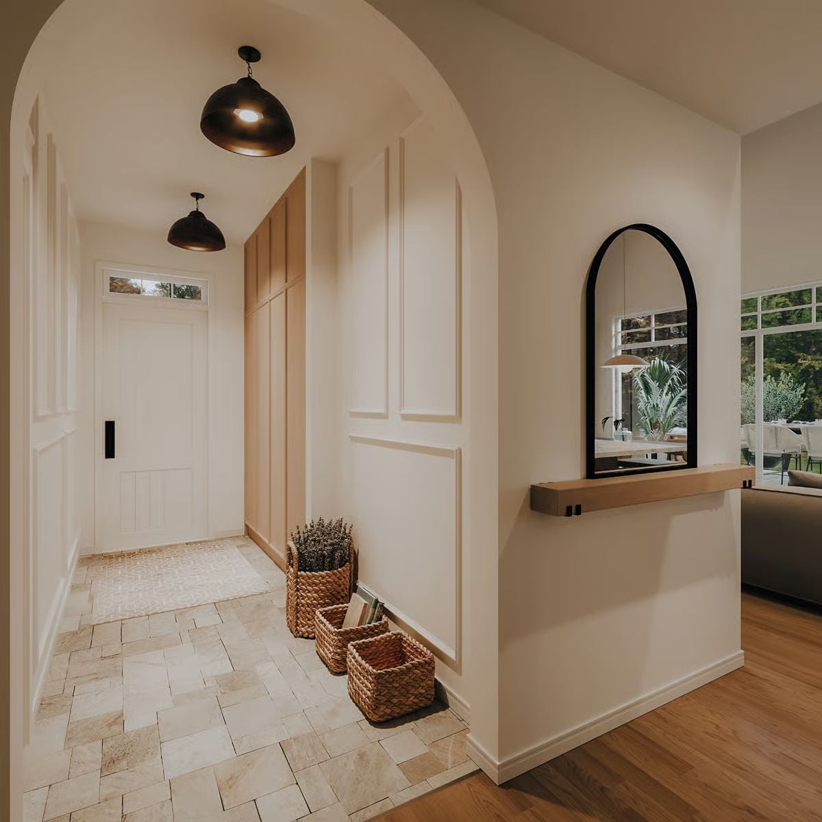 Arched Entry with Stone Tile and Woven Baskets Sets a Calm First Impression