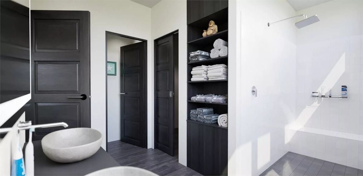 Black Doors, Stone Vessel Sink, and Shelves Stacked with Folded Towels