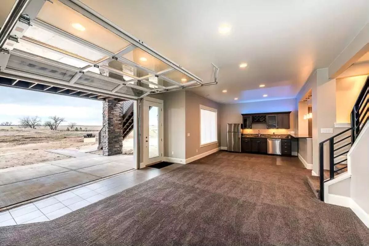 Glass Garage Door Opens the Whole Room to the Outside