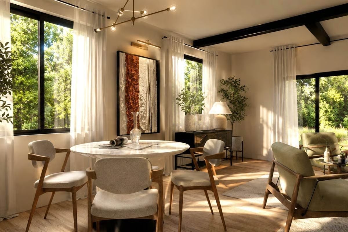 Sheer Curtains, Exposed Beams, and a Round Marble Table Earning Its Keep