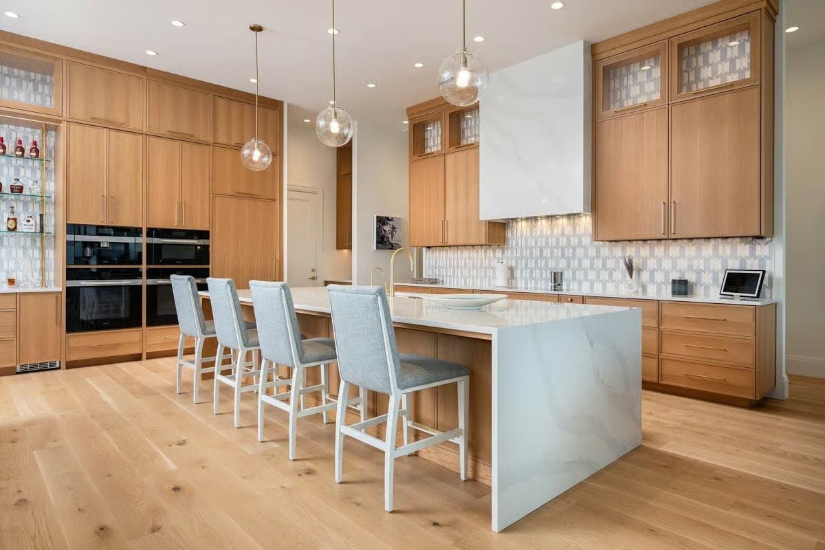 Warm Oak Cabinetry and Waterfall Marble Make a Strong Case for Restraint