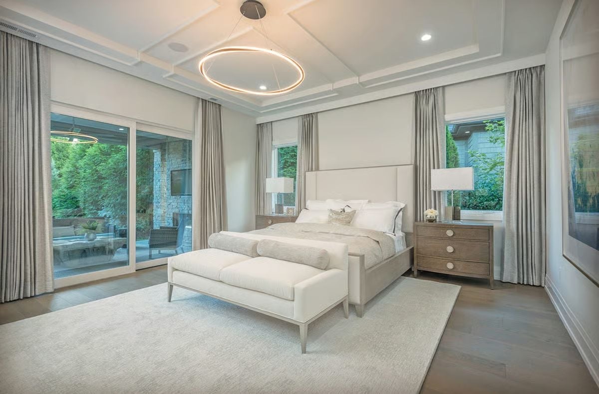 Circular Pendant, Coffered Ceiling, and a Bed That Commands the Room Without Trying