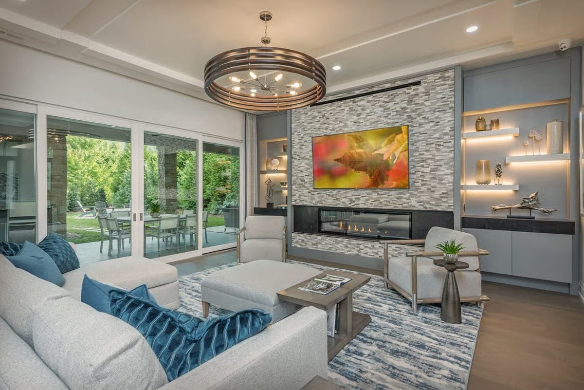 Stacked Stone, Low Flame, and a Chandelier That Earns Its Square Footage