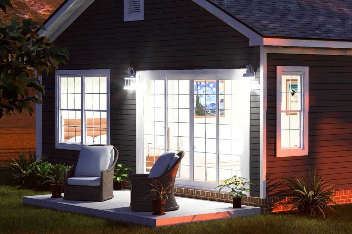 Barn Sconces and Wicker Chairs Make This Porch Worth Staying Up For