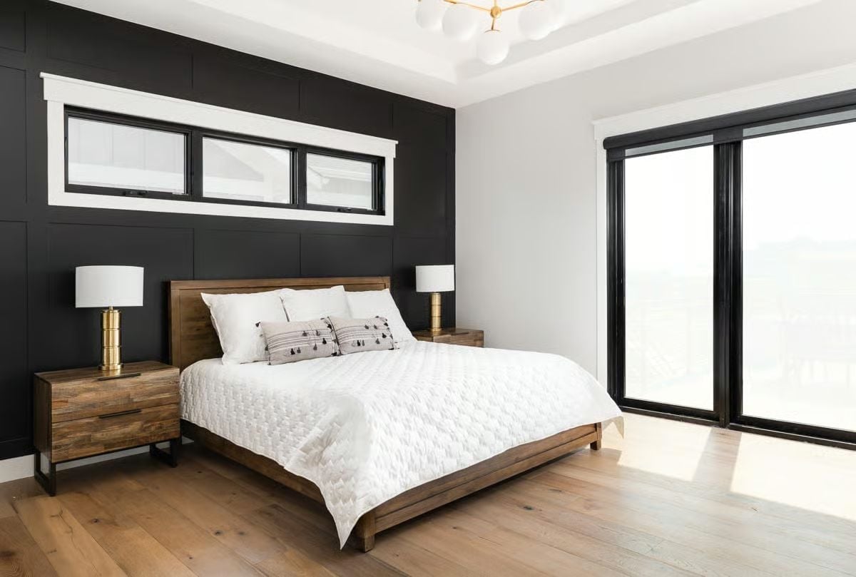 Black Accent Wall, Brass Lamps, and a Platform Bed That Anchors the Whole Room