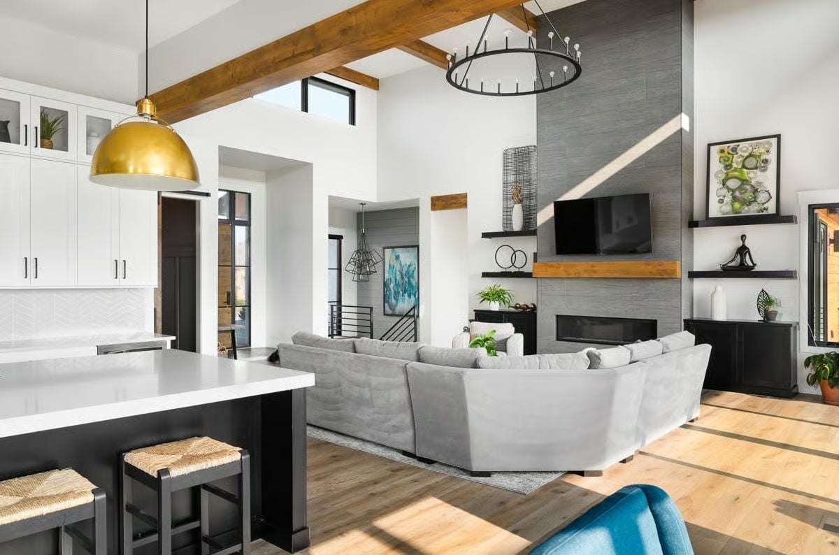 Gold Pendant, Exposed Beam, and a Fireplace Wall That Earns Its Height
