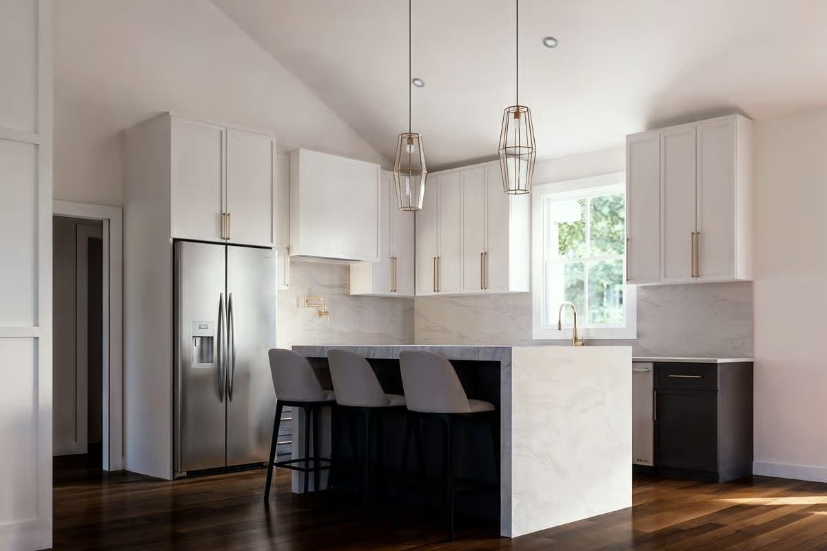 Waterfall Island, Brass Cage Pendants, and Two-Tone Cabinets That Actually Work