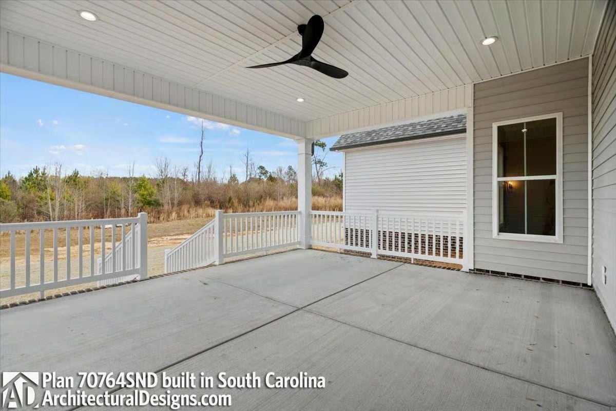 Covered Rear Porch With Ceiling Fan Proves Outdoor Living Doesn't Need Furniture to Function