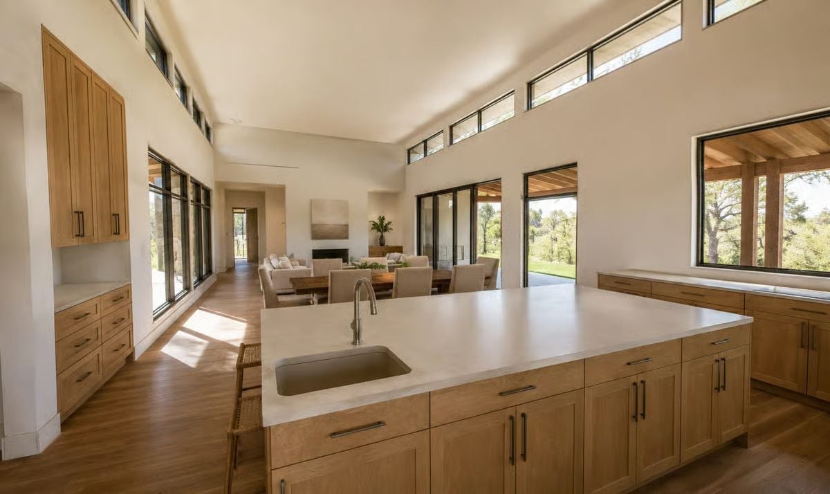Warm Oak Cabinetry and a Waterfall Island Define This Open Hill Country Kitchen