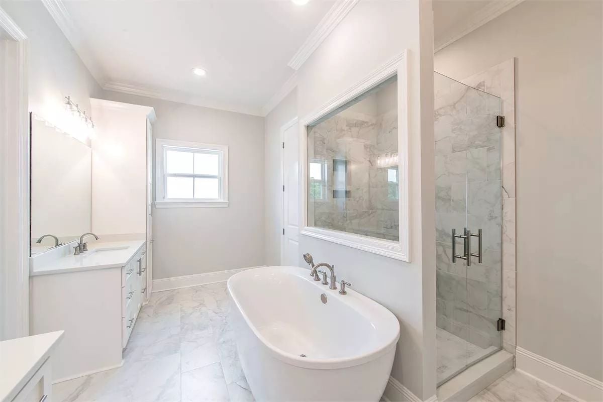Freestanding Soaker and a Frameless Shower Make Sharing a Bath Feel Less Like a Compromise