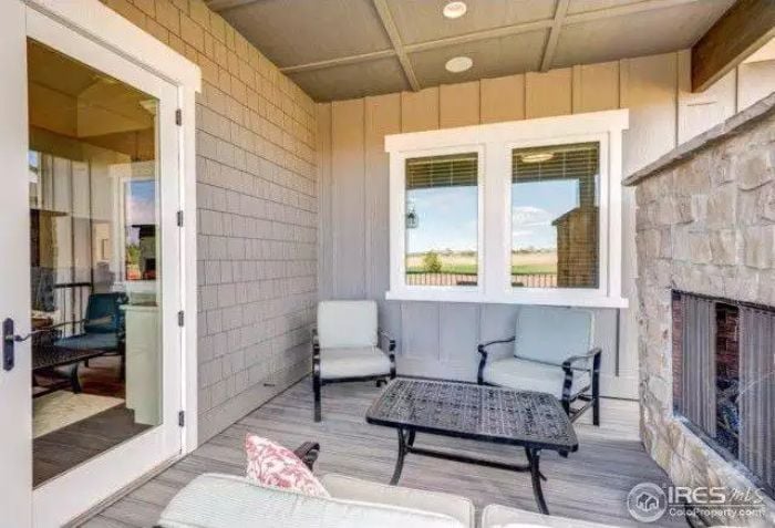 Covered Porch with a Stone Fireplace That Makes Fall Evenings Worth Planning Around