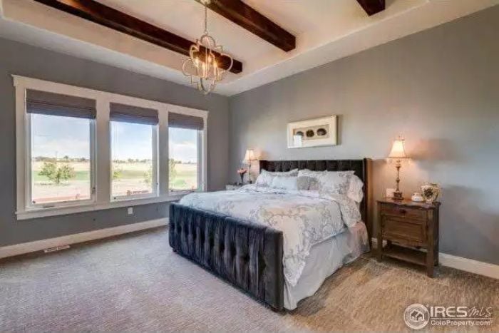Tufted Velvet Footboard and Exposed Beams Make a Case for Staying in Bed